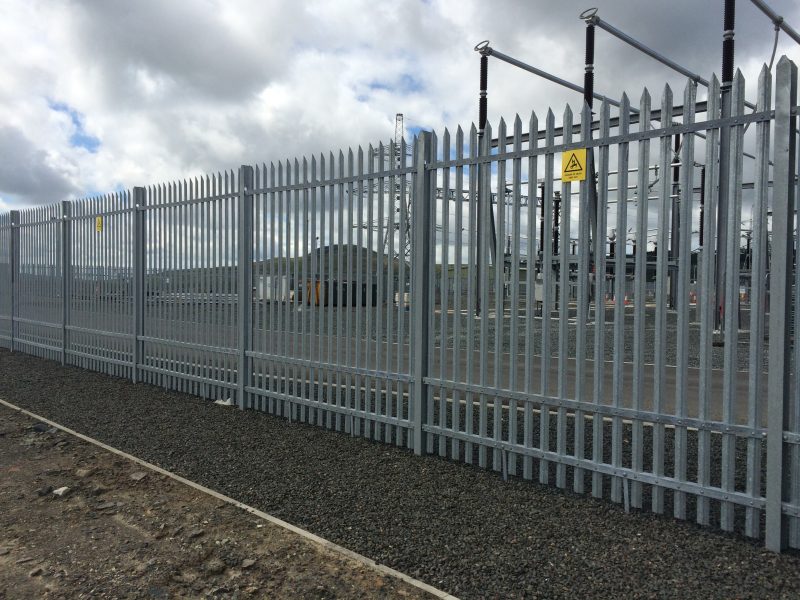 Metal palisade fencing.