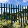 A Lochrin Classic™ steel palisade fence protecting the perimeter of a storage yard.