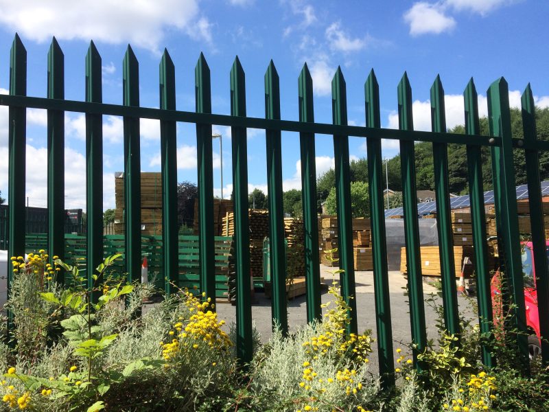 A Lochrin Classic™ steel palisade fence protecting the perimeter of a storage yard.